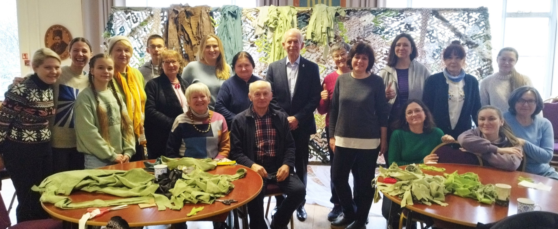 4 March 2023 – Ukraine Social Club in Gloucester witnessing hand-making camouflage nets for the front line from a donation of 1100 sets of old bed linen – the colours are tuned to the seasonal need in theatre.
